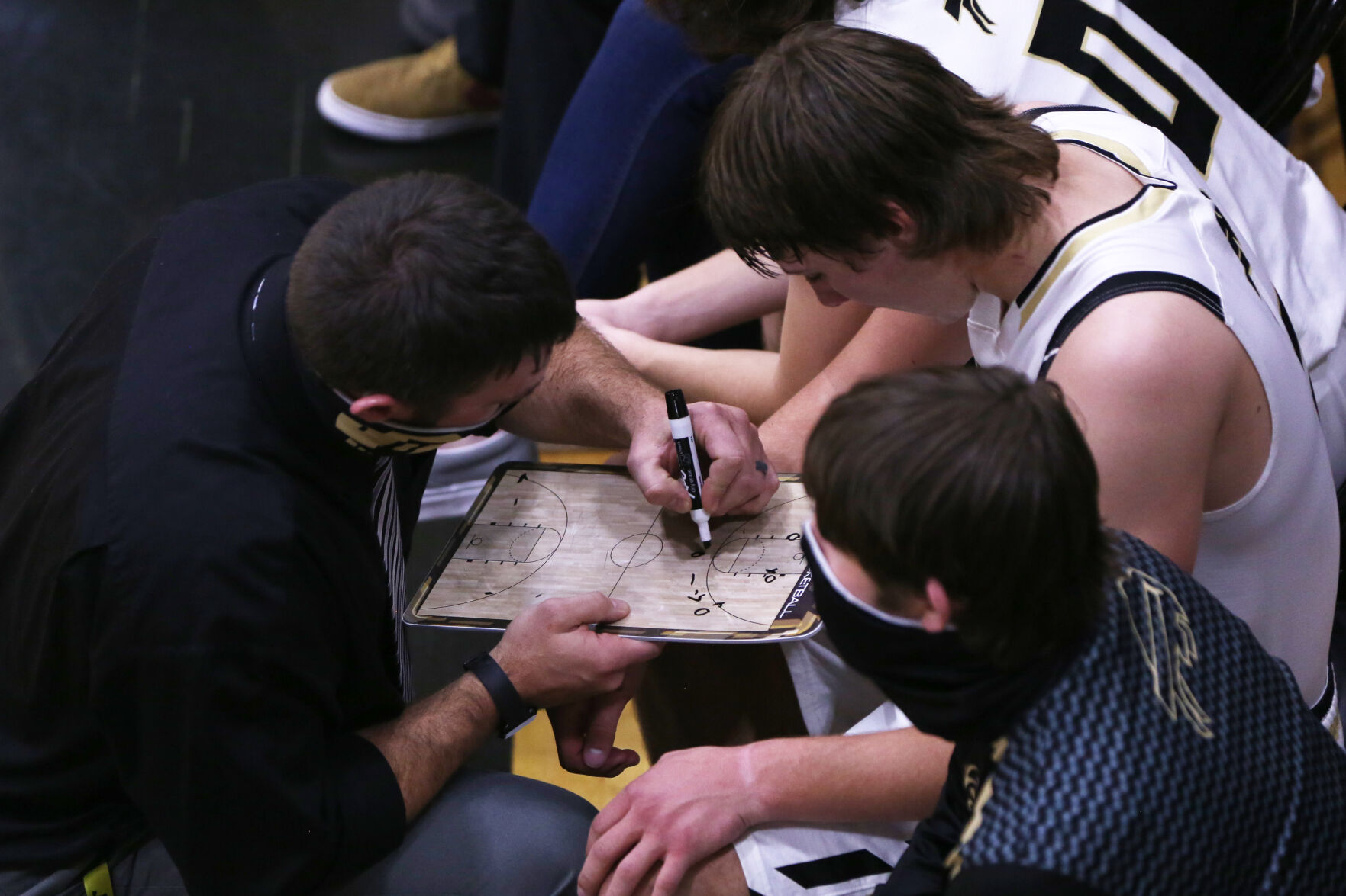 Hunter Stone talks through a play with assistant coach Ross Walker